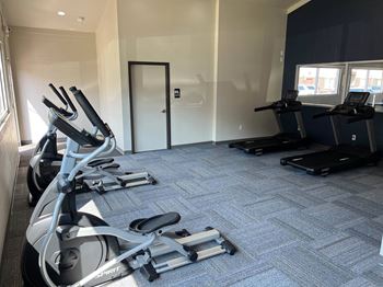 a gym with treadmills and elliptical machines  at Courtyard Apartments, Moorhead, MN, 56560